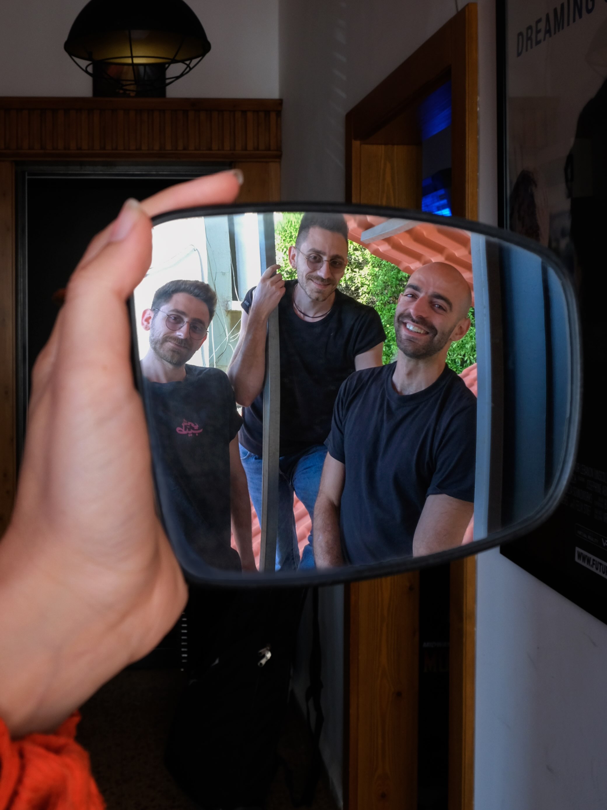 The band reflected in a handheld mirror