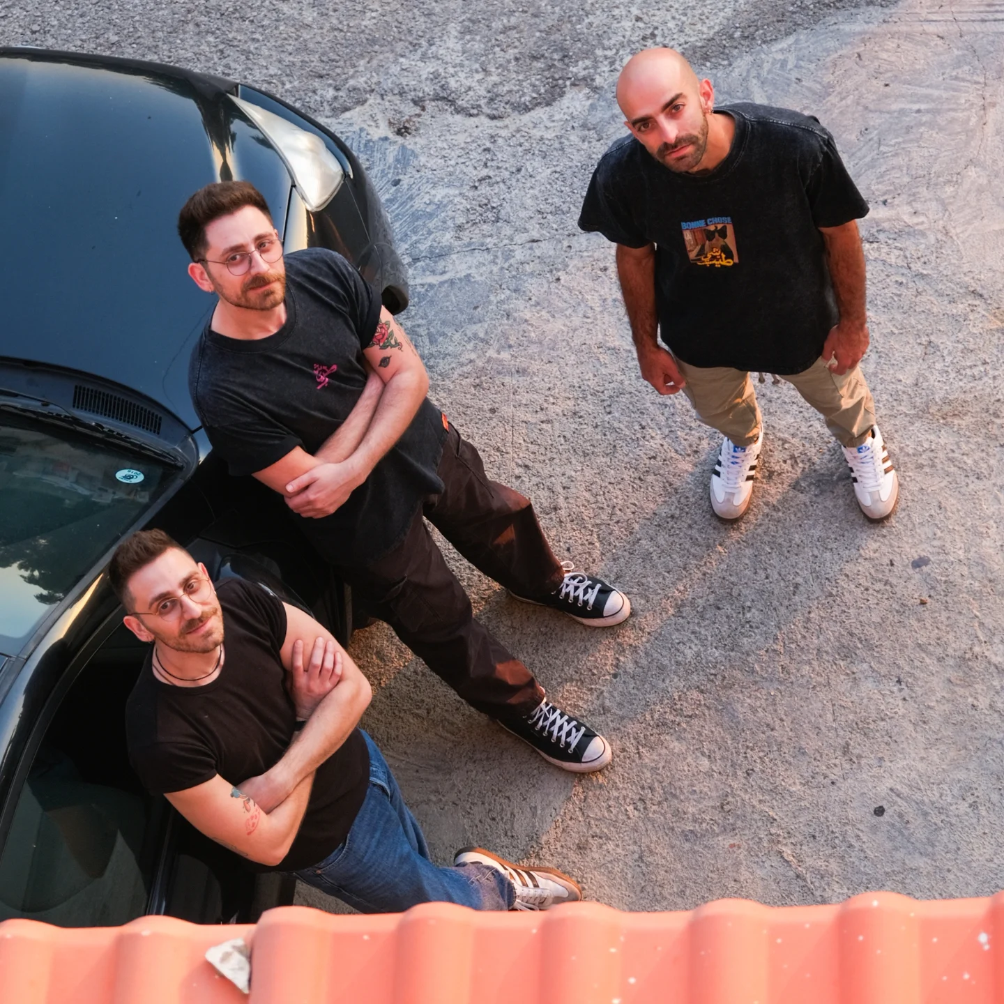 All three members of Bonne Chose beside a van